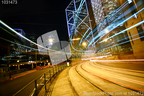 Image of light trails on the modern building background