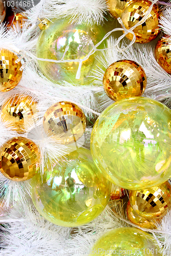 Image of Christmas balls on white feathers