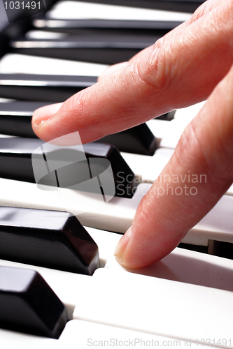 Image of hands playing music on the piano, hands and piano player, keyboa