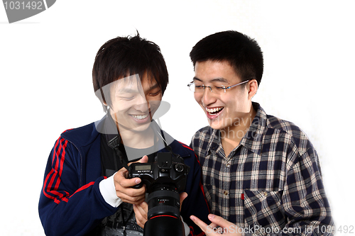 Image of two asian man watching the photo in camera