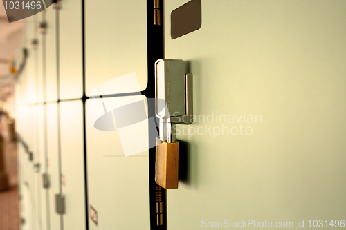 Image of Closeup view of a lock on a school locker with row of lockers 