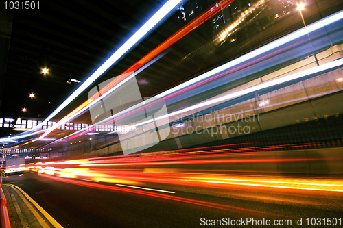 Image of light trails on the modern building background