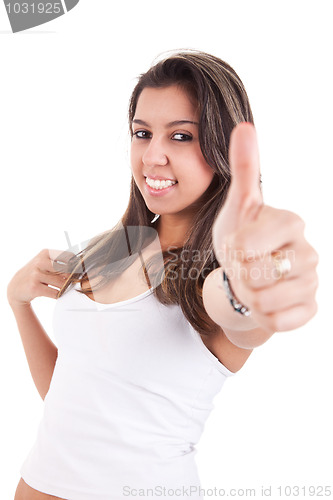 Image of pretty girl with thumb raised as a sign of success,