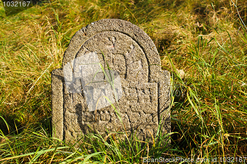 Image of detail of tomb on forgotten and unkempt Jewish cemetery with the strangers