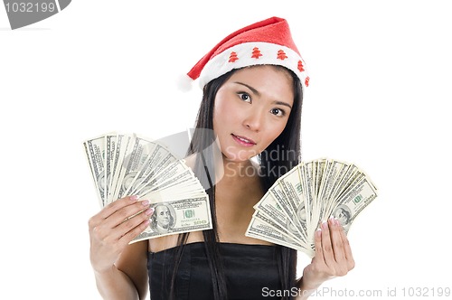 Image of woman with santa claus hat and money