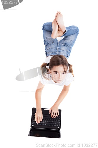 Image of Little student girl with a laptop
