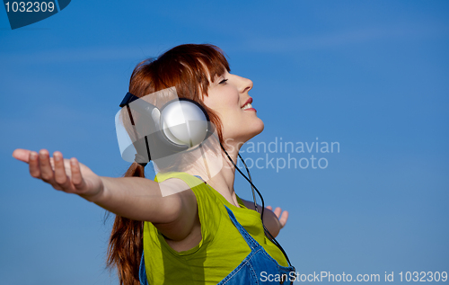 Image of Happy woman listen music