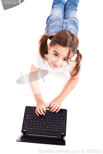 Image of Little student girl with a laptop