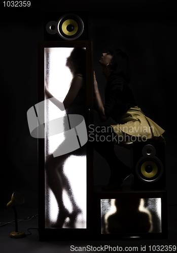 Image of A girl behind the glass door  