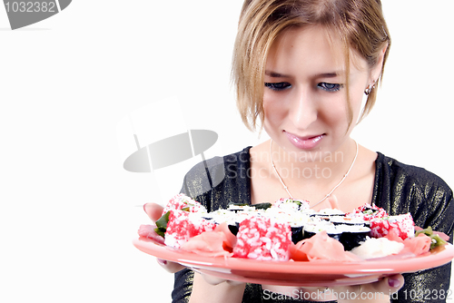 Image of young girl  with sushi set