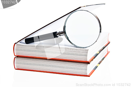 Image of Two books and magnifier, it is isolated on white