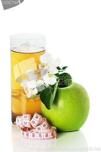 Image of green apple and blossoming branch 