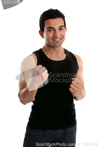 Image of Adult male holding up two fists and smiling
