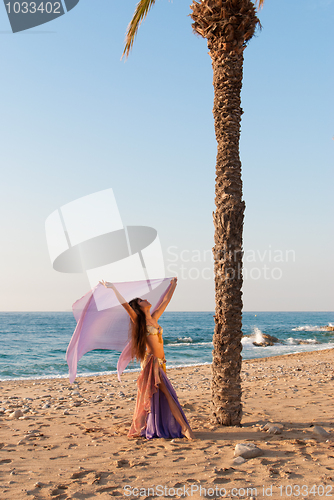 Image of Oriental dancer performing on a beach