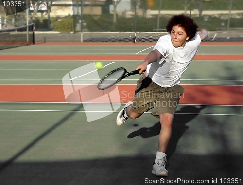 Image of Teenage boy playing tennis