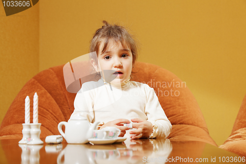 Image of Little girl with toy dishware