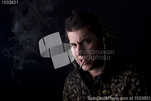 Image of portrait of a young man with cigarette  