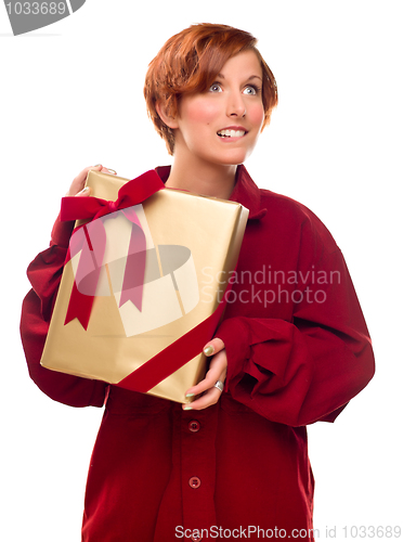 Image of Pretty Red Haired Girl Biting Lip Holding Wrapped Gift