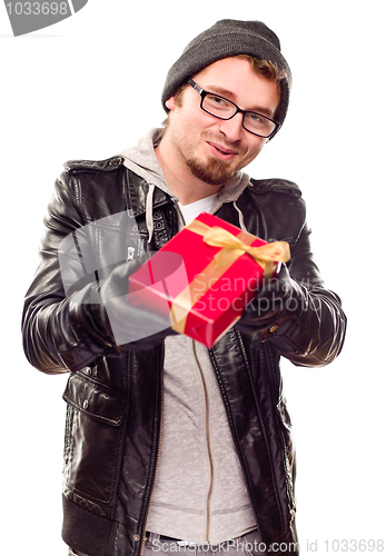 Image of Warmly Dressed Young Man Handing Wrapped Gift Out