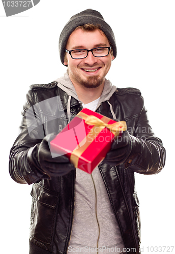 Image of Warmly Dressed Young Man Handing Wrapped Gift Out