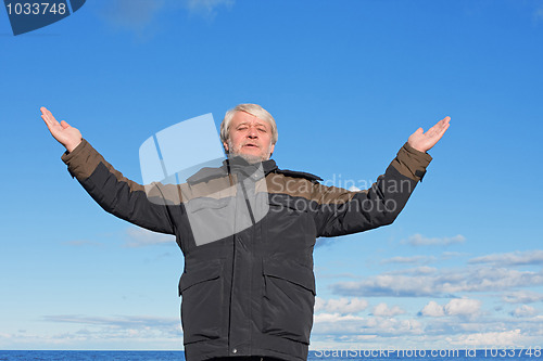 Image of Middle-aged man on blue sky of the background.