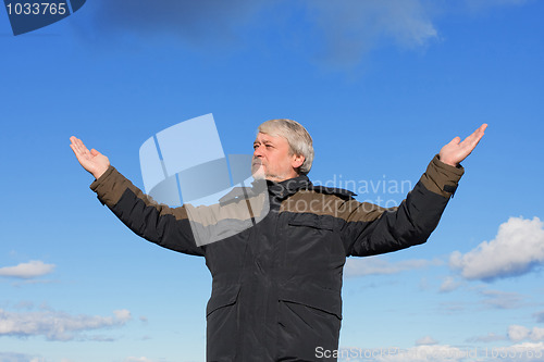 Image of Middle-aged man on blue sky of the background.