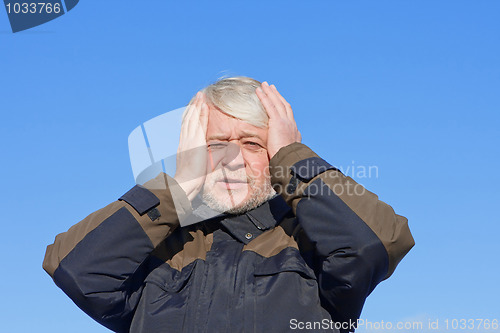Image of Portrait of middle-aged man on blue sky of the background.