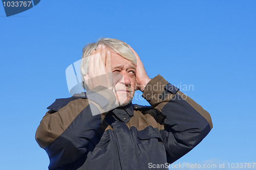 Image of Portrait of middle-aged man on blue sky of the background.