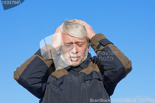 Image of Portrait of middle-aged man on blue sky of the background.