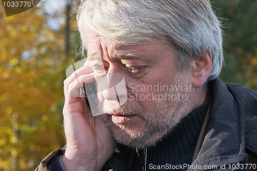 Image of Portrair of mature middle-aged man in forest.