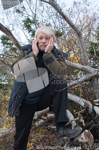 Image of Mature middle-aged man in forest.