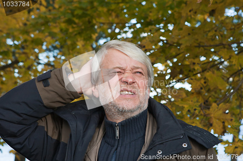 Image of Portrait of middle-aged man in autumn day.