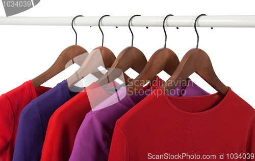 Image of Red and purple casual shirts on hangers