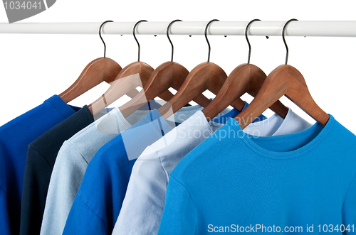 Image of Casual shirts on hangers, different tones of blue