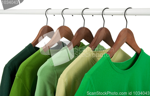 Image of Casual shirts on hangers, different tones of green