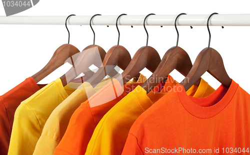 Image of Yellow and orange casual shirts on hangers