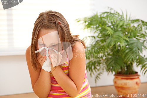 Image of Teen girl blowing out her nose