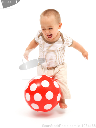 Image of Little boy playing with red ball