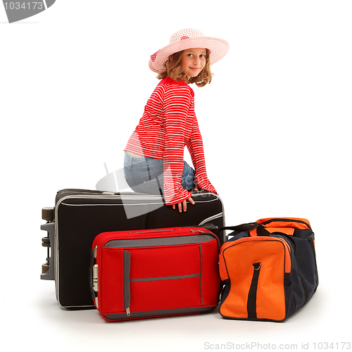 Image of Girl sitting on luggage
