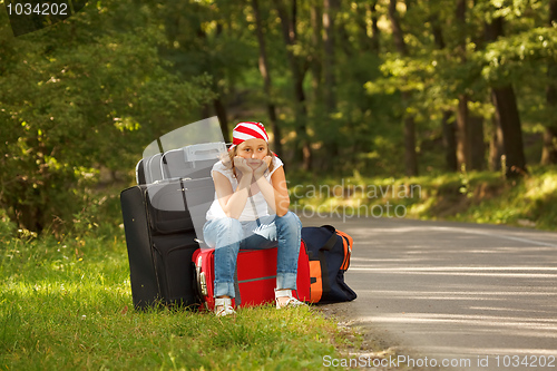 Image of Young hitch-hiker girl