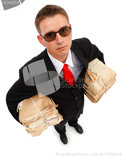 Image of Businessman with lots of paperwork