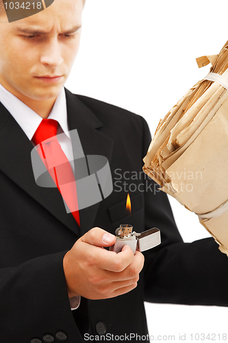 Image of Young man burning file folder