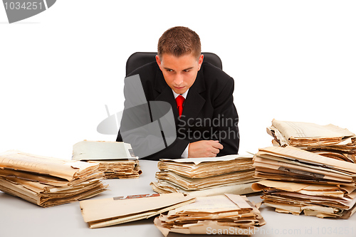 Image of Man looking at lots of documents