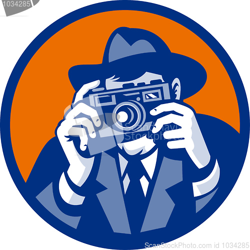 Image of Photographer with fedora hat aiming retro slr camera
