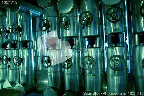 Image of different size and shaped pipes and valves at a power plant 