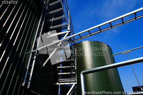Image of Industrial zone, Steel pipelines and tanks against blue sky