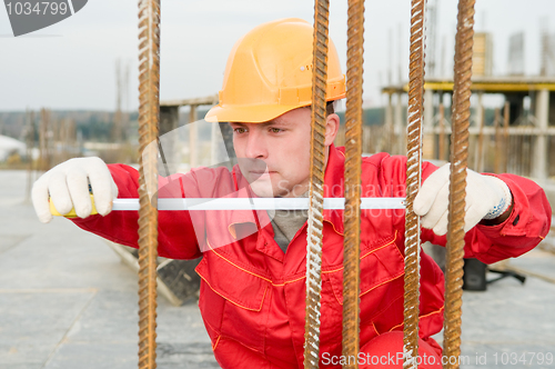 Image of builder with measure tape