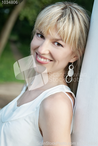 Image of young smiley woman outdoors