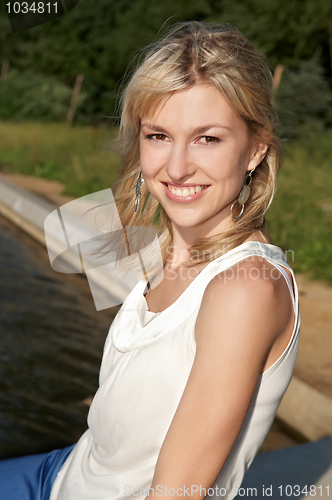 Image of smiley woman on a lake