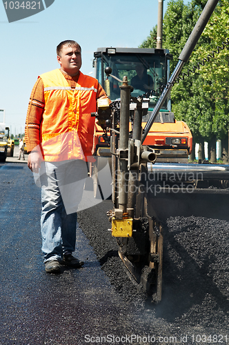 Image of Young paver worker at asphalting works